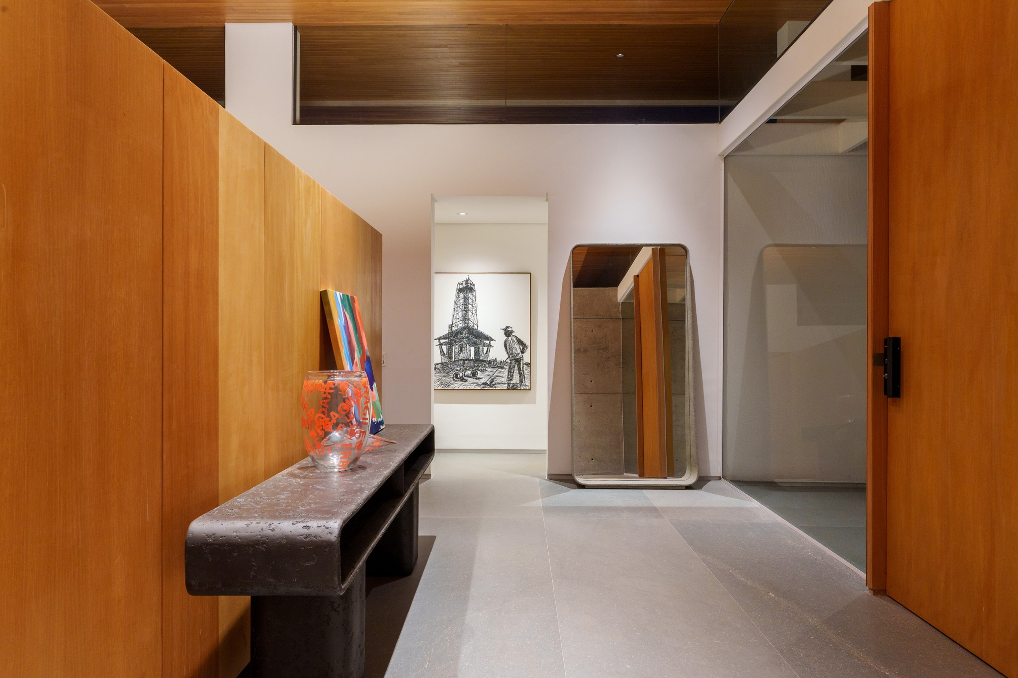 Corredor interno com decoração, bancos e iluminação noturna